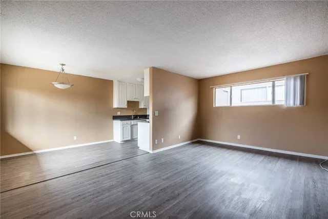 a view of kitchen with wooden floor and electronic appliances