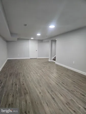 a view of dirt yard with a large tree