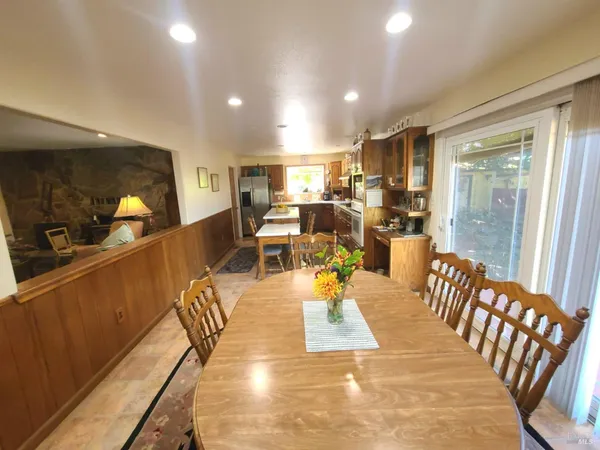 a living room with furniture a ceiling fan and a window