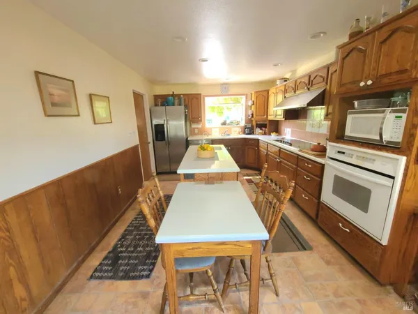 a kitchen with a sink stove and wooden cabinets