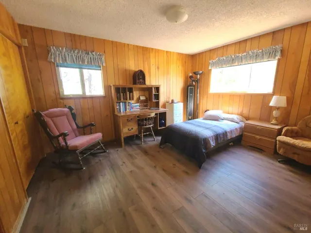 a bed sitting in a bedroom next to a window