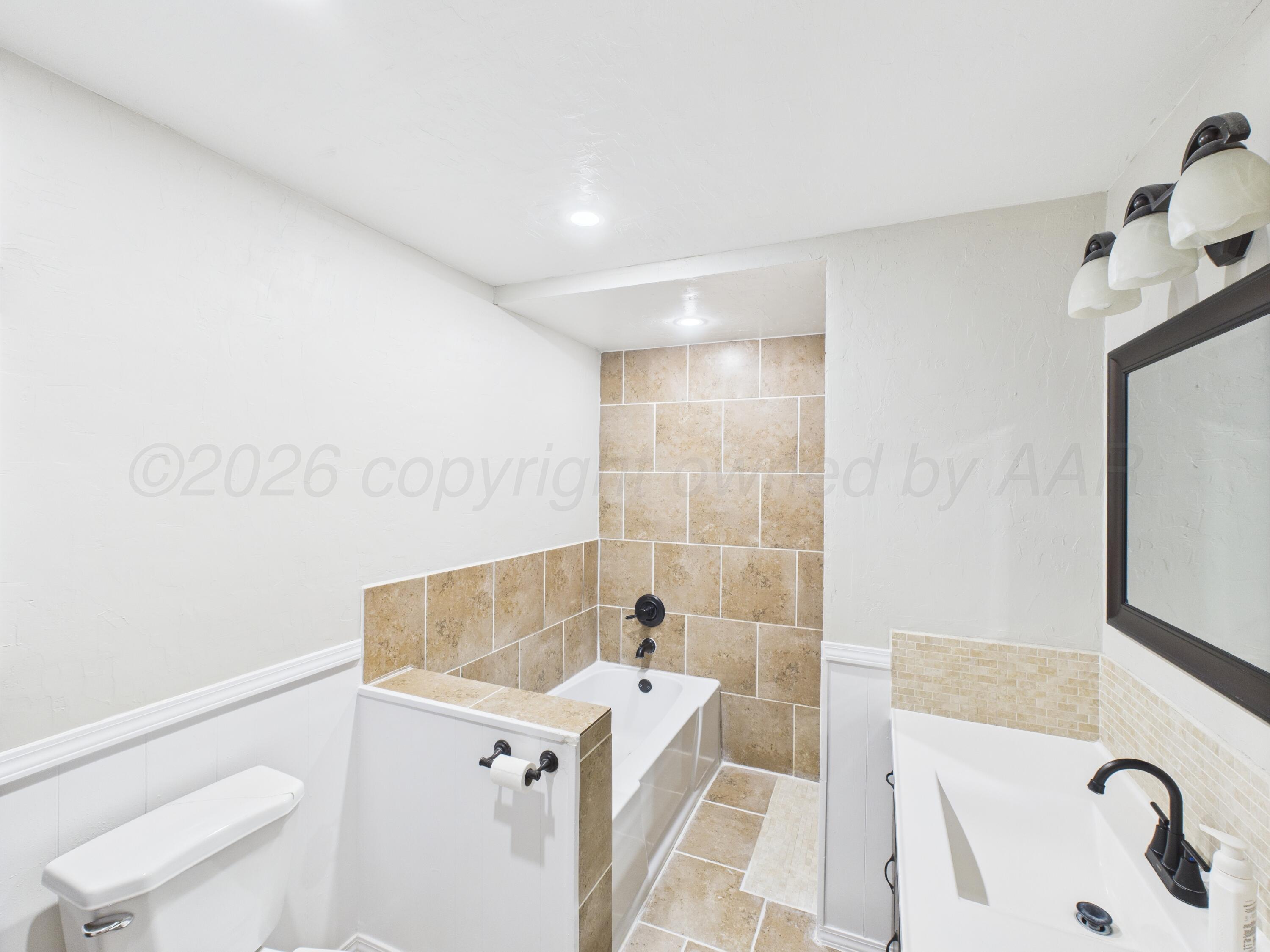 505 South Ridgeland Avenue Fritch, TX 79036 - Photo 14 of 15 a bathroom with a sink a toilet and shower