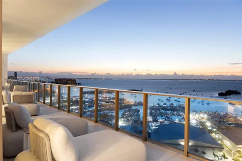 a living room with furniture potted plant and a large window