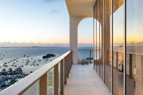 a dining room with furniture potted plants and wooden floor