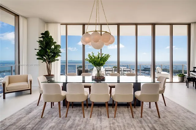 a living room with furniture and floor to ceiling windows