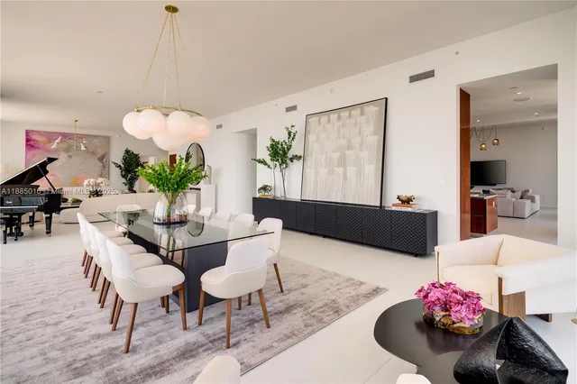 a large kitchen with stainless steel appliances a stove and a flat screen tv