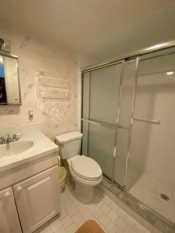 a bathroom with a toilet a sink and a shower