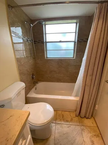 a bathroom with a toilet and a bathtub