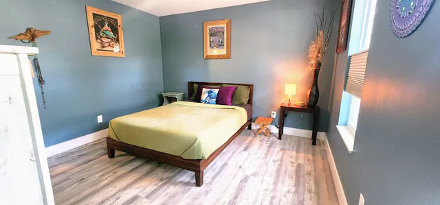 a bed sitting in a bedroom next to a window