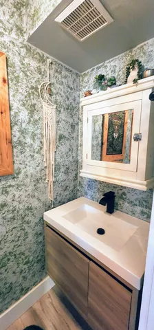 a bathroom with a sink and a window