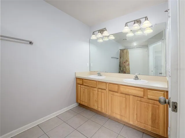 a bathroom with a double vanity sink and a mirror