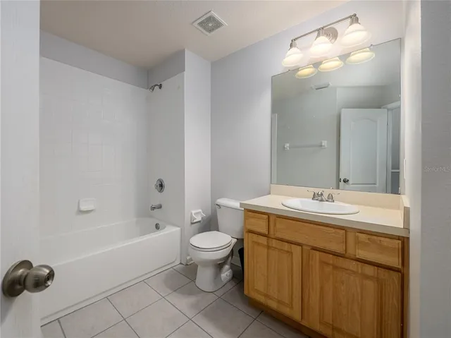 a bathroom with a double vanity sink mirror and toilet