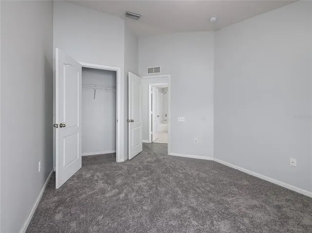 an empty room that has a grey walls