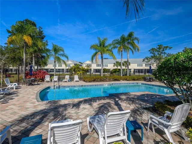 a view of a backyard with swimming pool