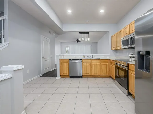 a large kitchen with cabinets and stainless steel appliances