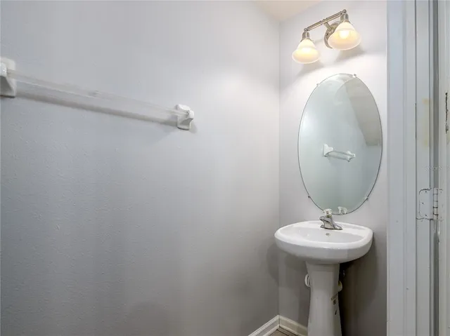 a bathroom with a sink and mirror