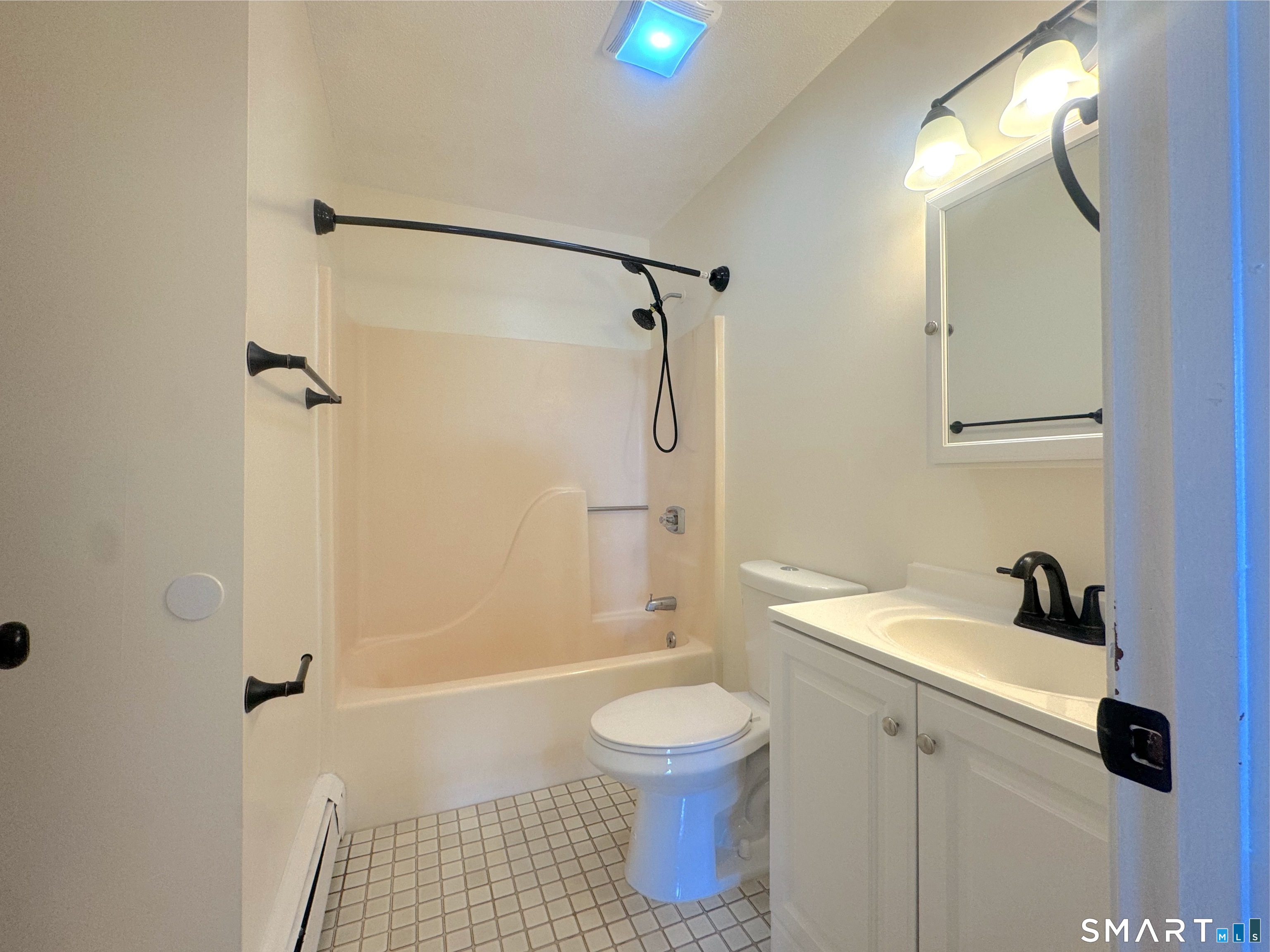 666 Broad Street, Unit 7 Meriden, CT 06450 - Photo 2 of 12 a bathroom with a sink a toilet and shower