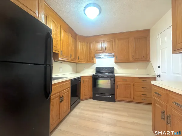 a kitchen with stainless steel appliances granite countertop a refrigerator stove and sink