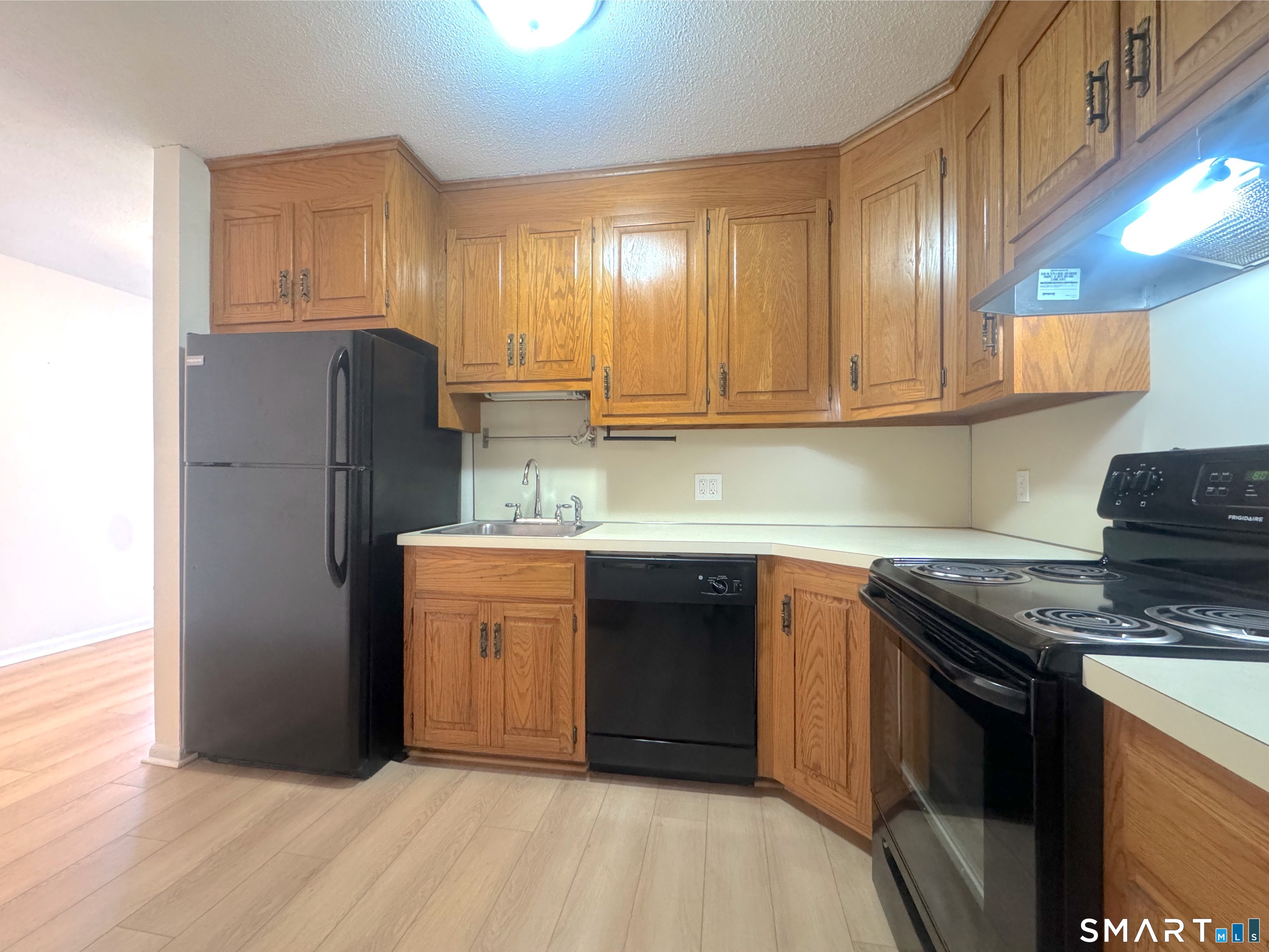 666 Broad Street, Unit 7 Meriden, CT 06450 - Photo 4 of 12 a kitchen with stainless steel appliances granite countertop a refrigerator stove and sink