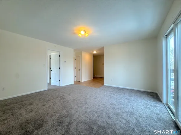 a view of an empty room and wooden floor