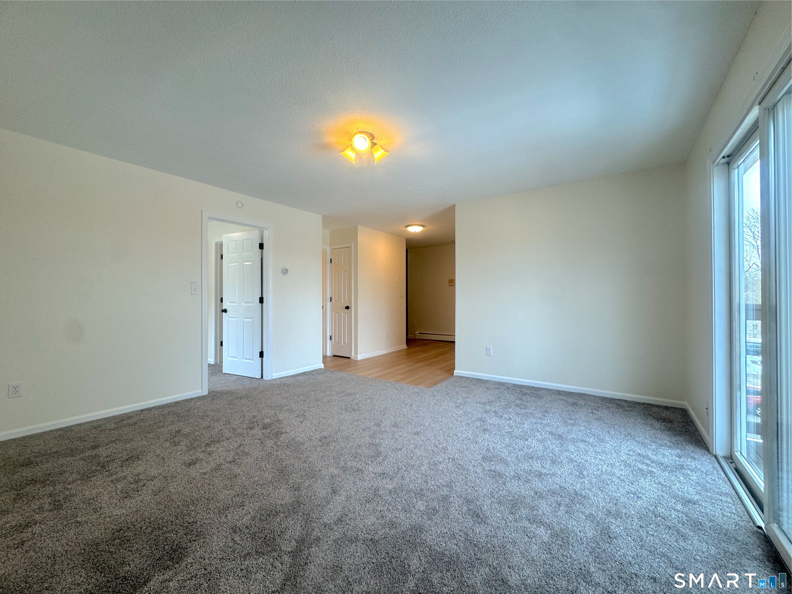 666 Broad Street, Unit 7 Meriden, CT 06450 - Photo 8 of 12 a view of an empty room with a window