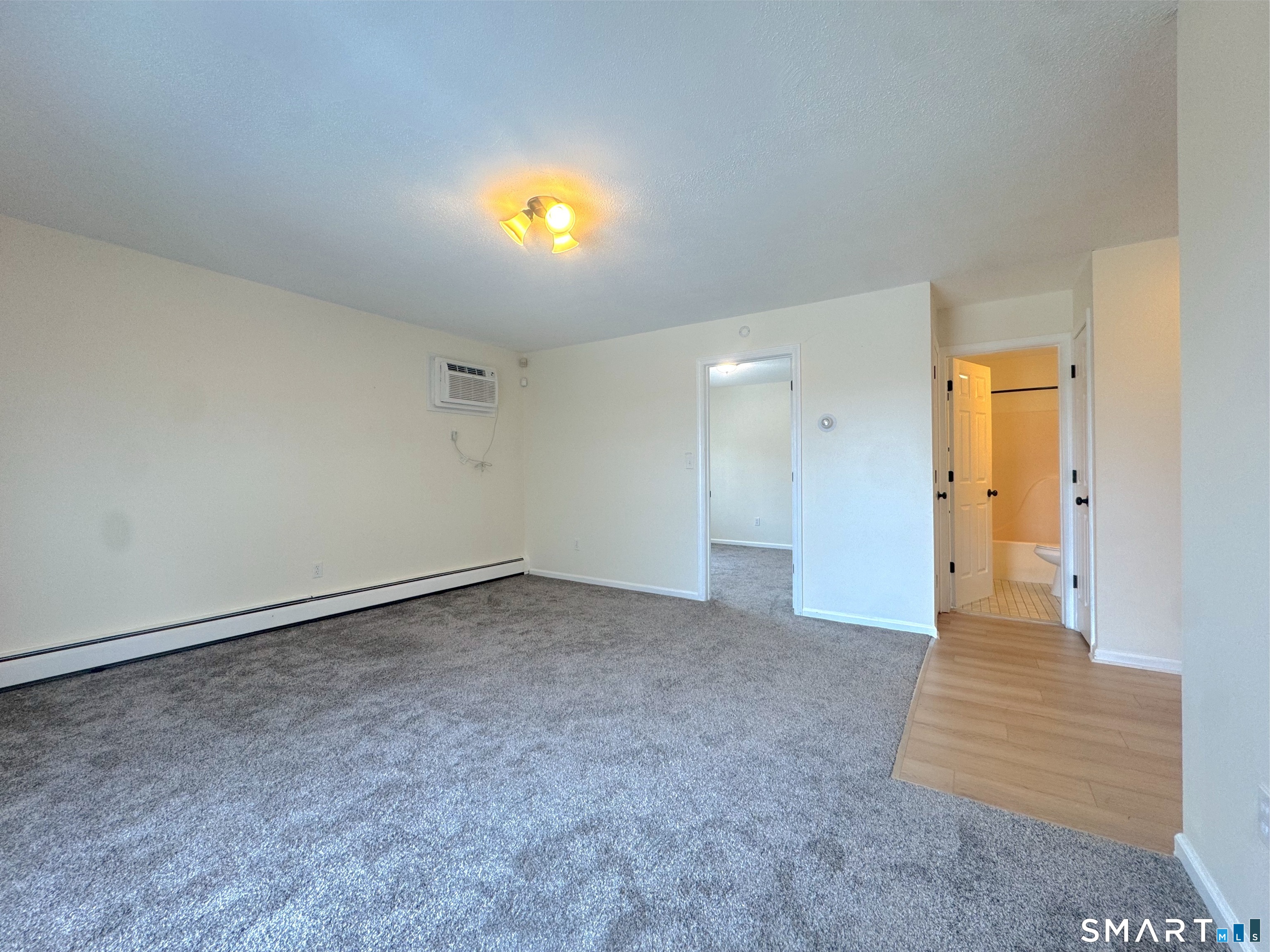 666 Broad Street, Unit 7 Meriden, CT 06450 - Photo 9 of 12 a view of an empty room and wooden floor