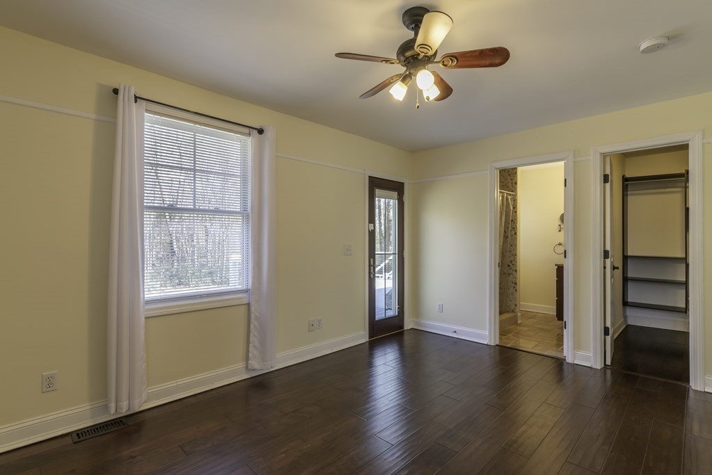 124 Southampton Road Westhampton, MA 01027 - Photo 11 of 25 an empty room with wooden floor chandelier fan and windows