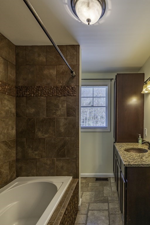 124 Southampton Road Westhampton, MA 01027 - Photo 17 of 25 a bathroom with a granite countertop sink a mirror and a bathtub