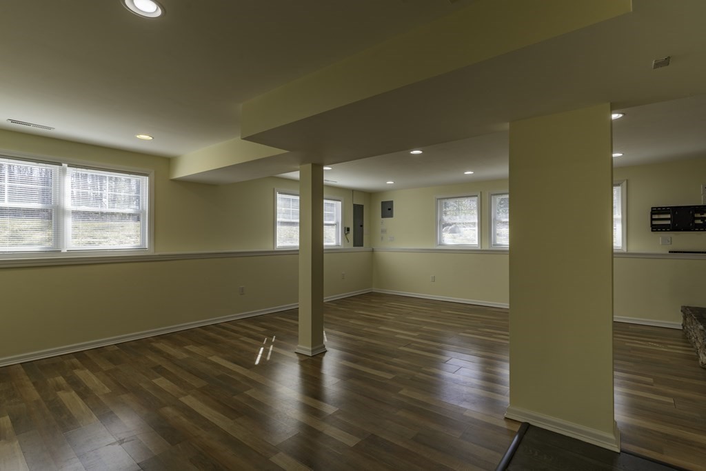 124 Southampton Road Westhampton, MA 01027 - Photo 21 of 25 a view of an empty room with wooden floor and a window
