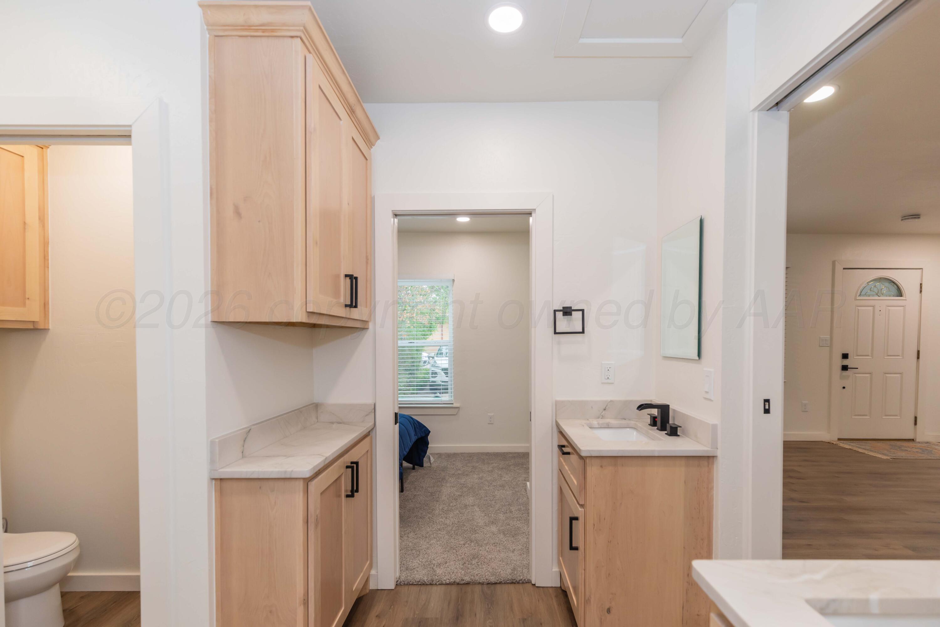 504 High Street Claude, TX 79019 - Photo 6 of 39 a bathroom with a sink a toilet and shower