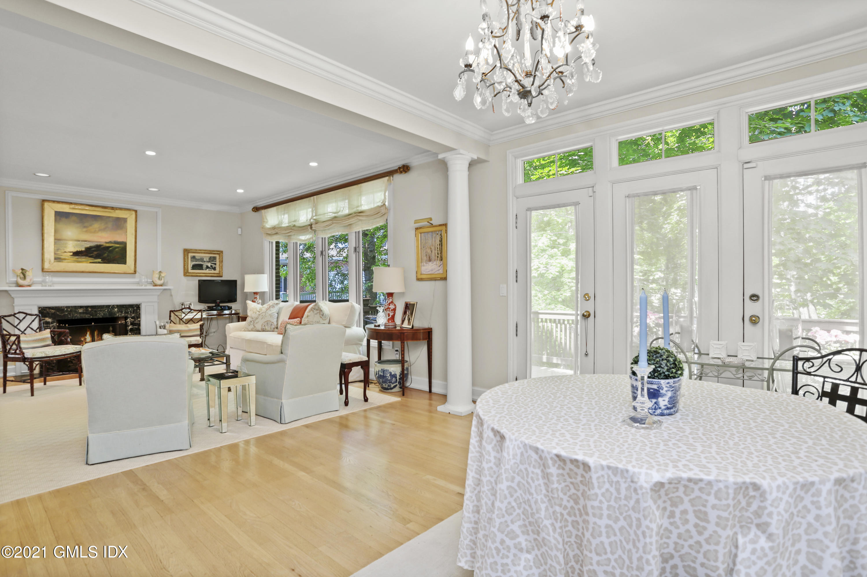 73 Weaver Street, Unit 4 Greenwich, CT 06831 - Photo 15 of 35 a view of a dining room with furniture a chandelier and large windows