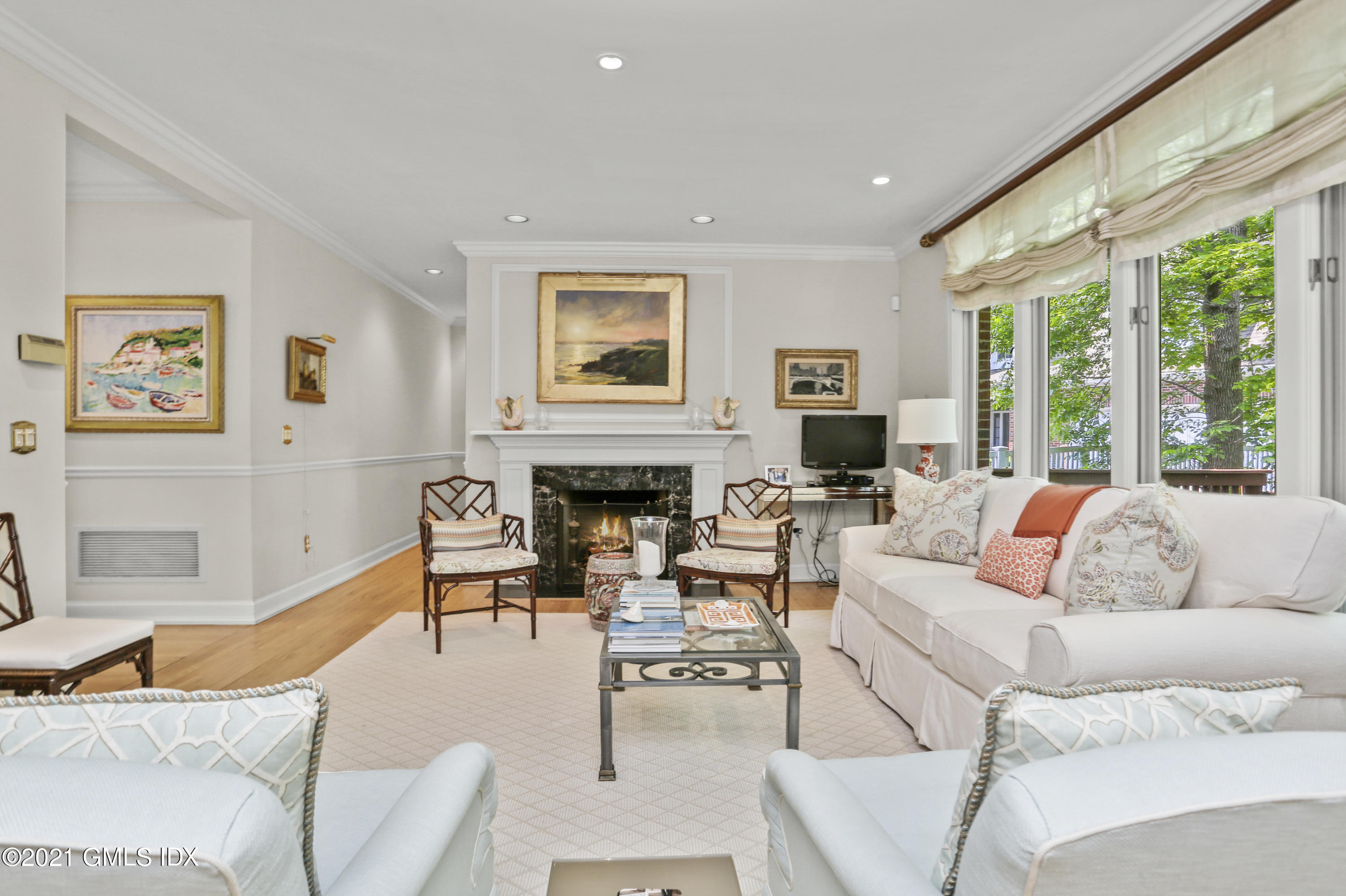 73 Weaver Street, Unit 4 Greenwich, CT 06831 - Photo 2 of 35 a living room with furniture large window and a fireplace