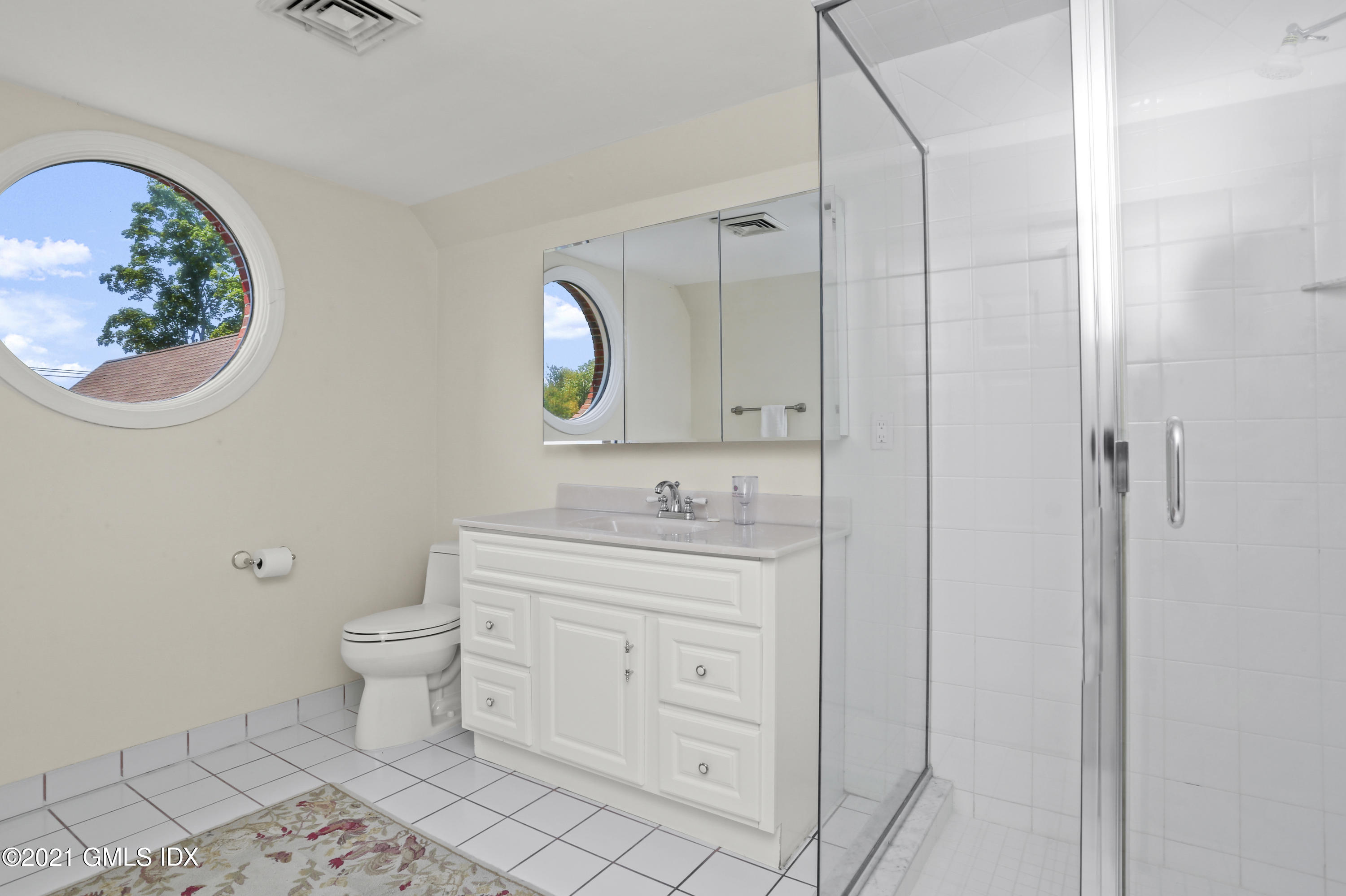 73 Weaver Street, Unit 4 Greenwich, CT 06831 - Photo 26 of 35 a bathroom with a sink a toilet and a mirror