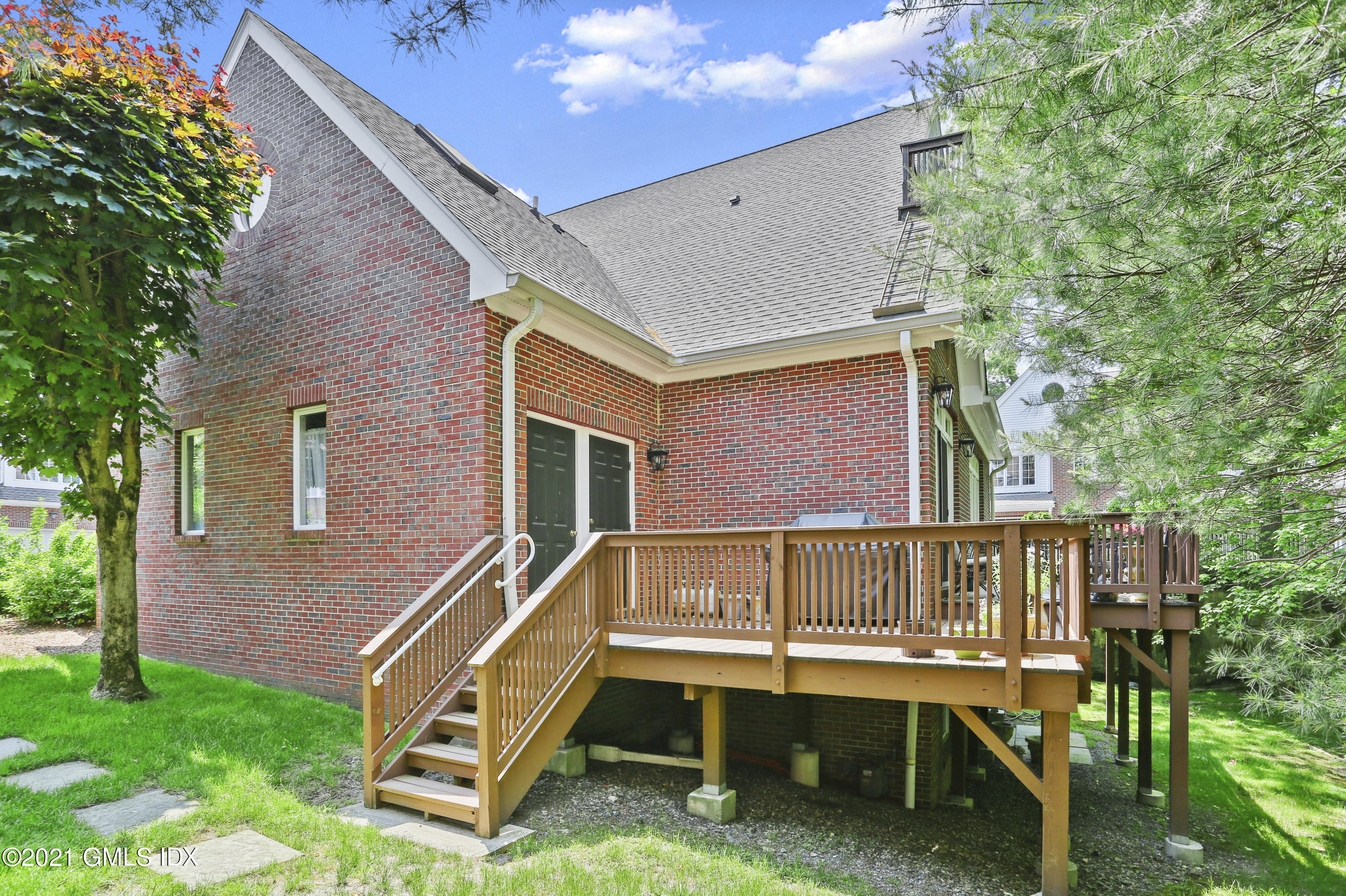 73 Weaver Street, Unit 4 Greenwich, CT 06831 - Photo 30 of 35 a wooden bench sitting in front of a house