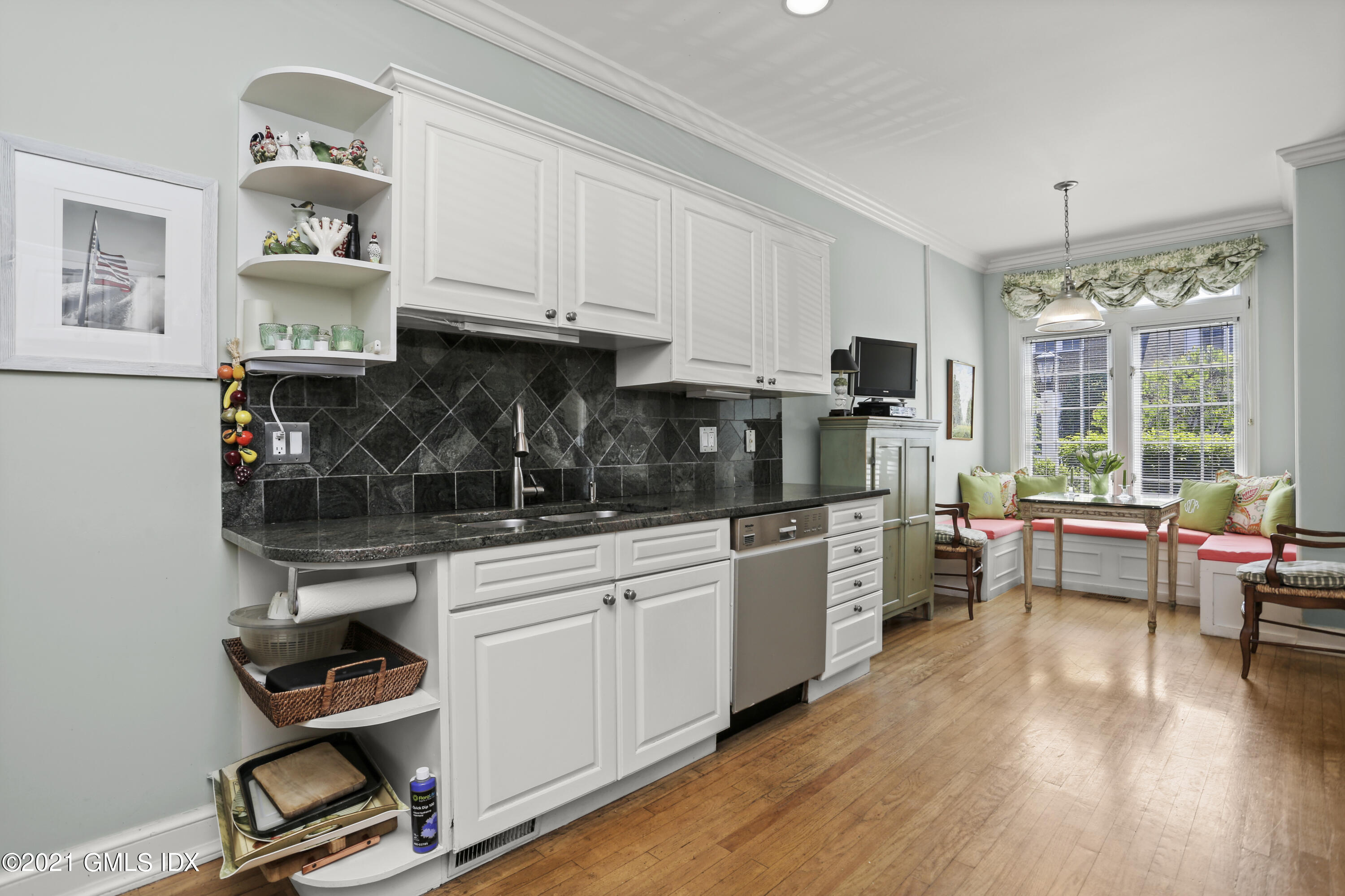 73 Weaver Street, Unit 4 Greenwich, CT 06831 - Photo 7 of 35 a kitchen that has a lot of cabinets a sink and wooden floor