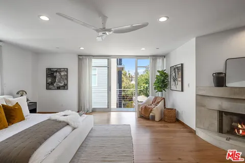 a bedroom with a large bed and a large window