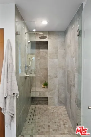 a bathroom with a shower and a sink