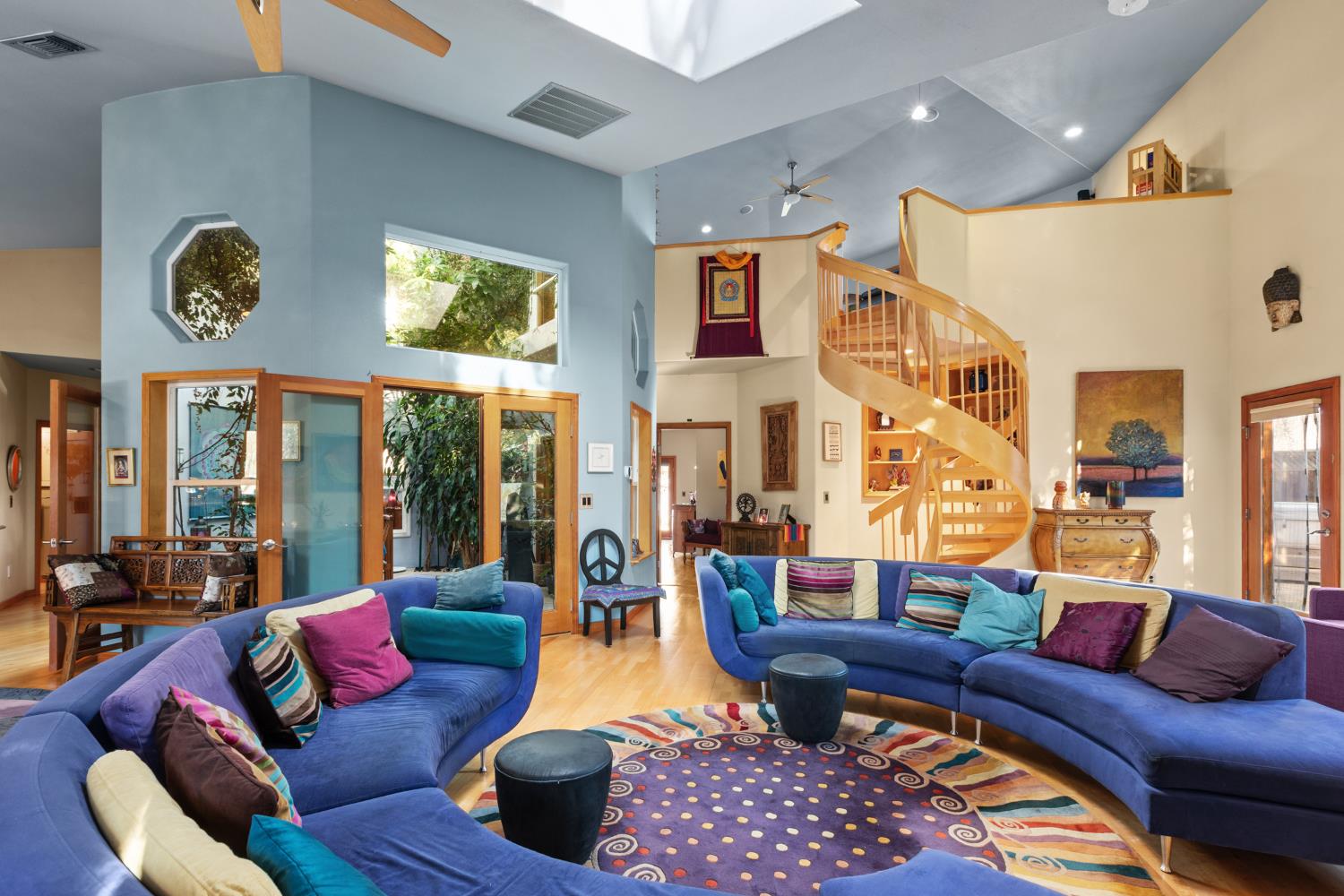 a living room with furniture fireplace and a large window