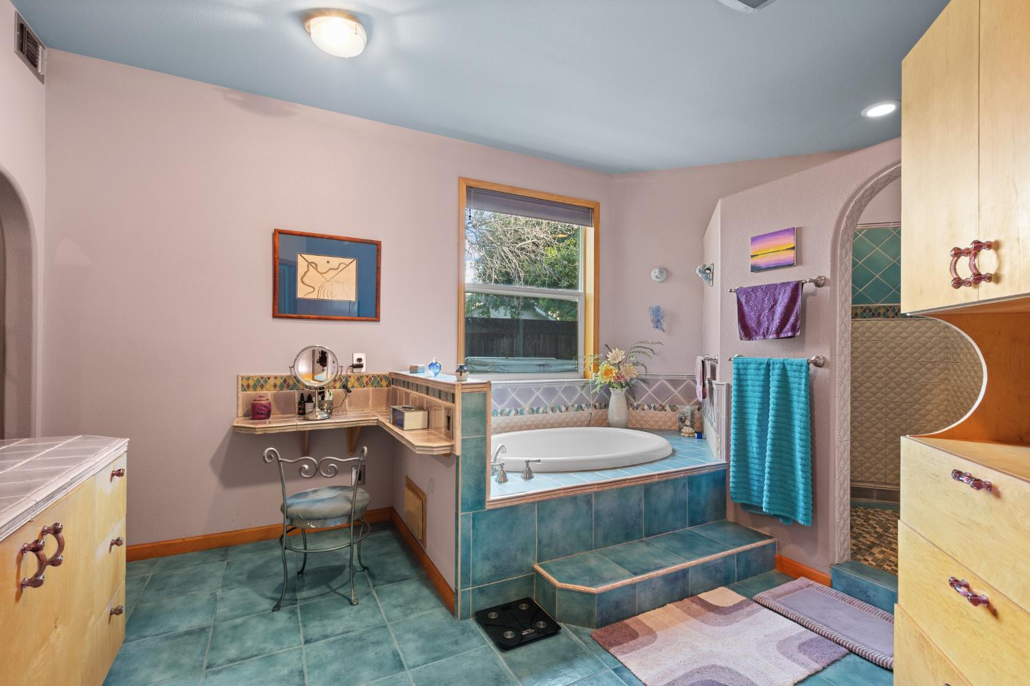 4838 Robertson Avenue Carmichael, CA 95608 - Photo 21 of 52 a spacious bathroom with a sink a mirror a toilet and a window