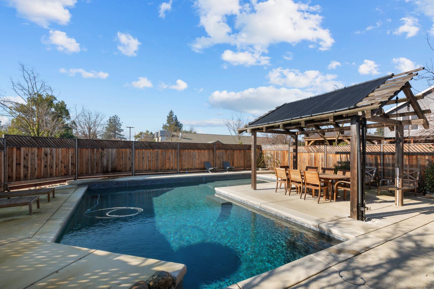 4838 Robertson Avenue Carmichael, CA 95608 - Photo 38 of 52 a view of a patio with table and chairs with wooden floor and fence