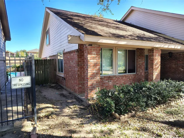 a view of a house with brick walls