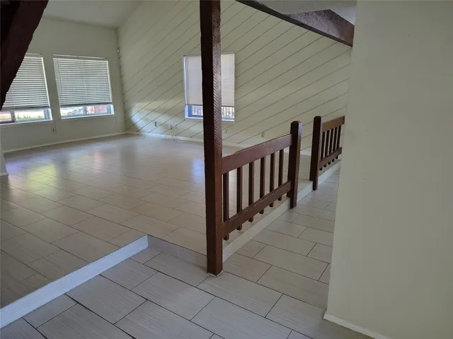 a view of a porch with wooden floor