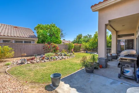 a view of a backyard with sitting area