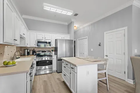 a kitchen with stainless steel appliances a stove refrigerator sink and cabinets