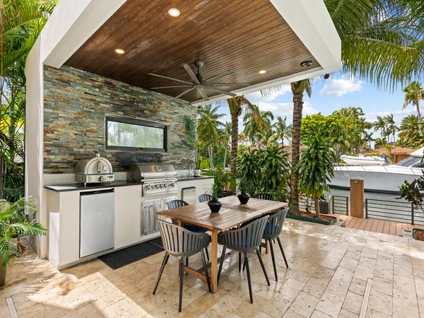 a living room with patio furniture and a floor to ceiling window