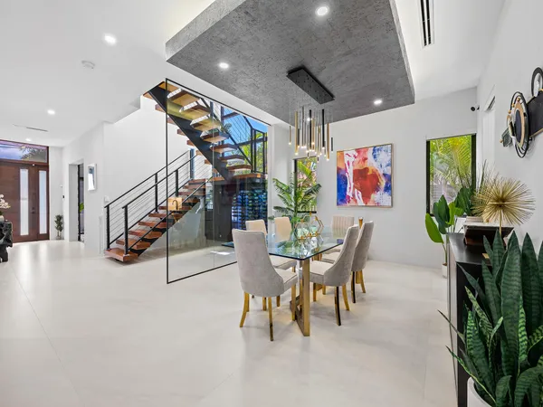 a living room with furniture a ceiling fan and a rug