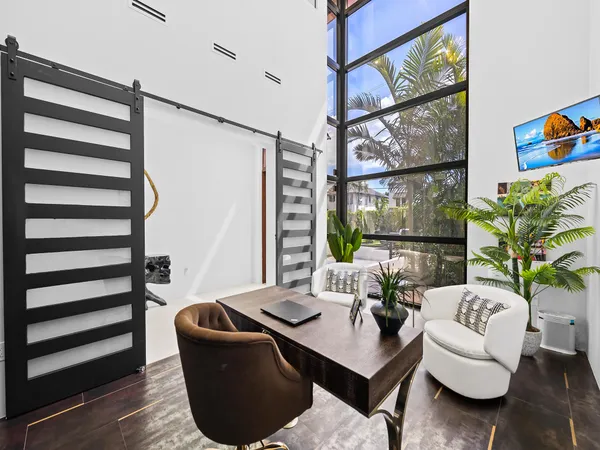 a kitchen with stainless steel appliances a table chairs refrigerator and stove