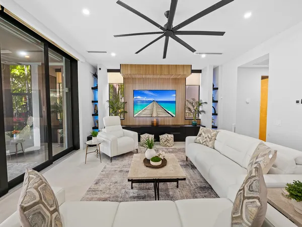 a kitchen with stainless steel appliances a stove and a flat screen tv