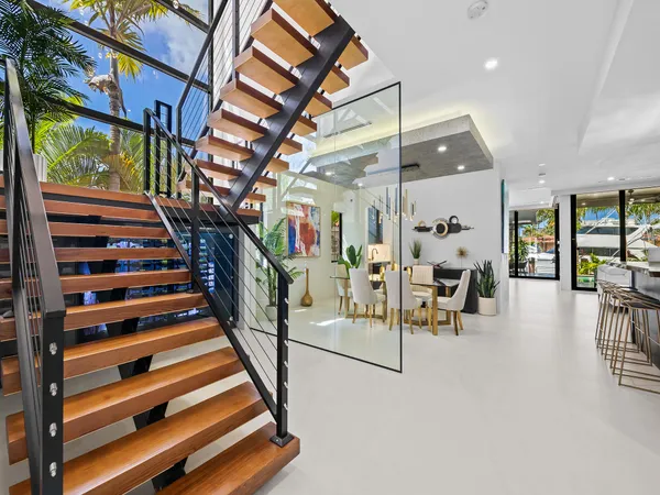 a view of a livingroom with a flesh screen tv and front door