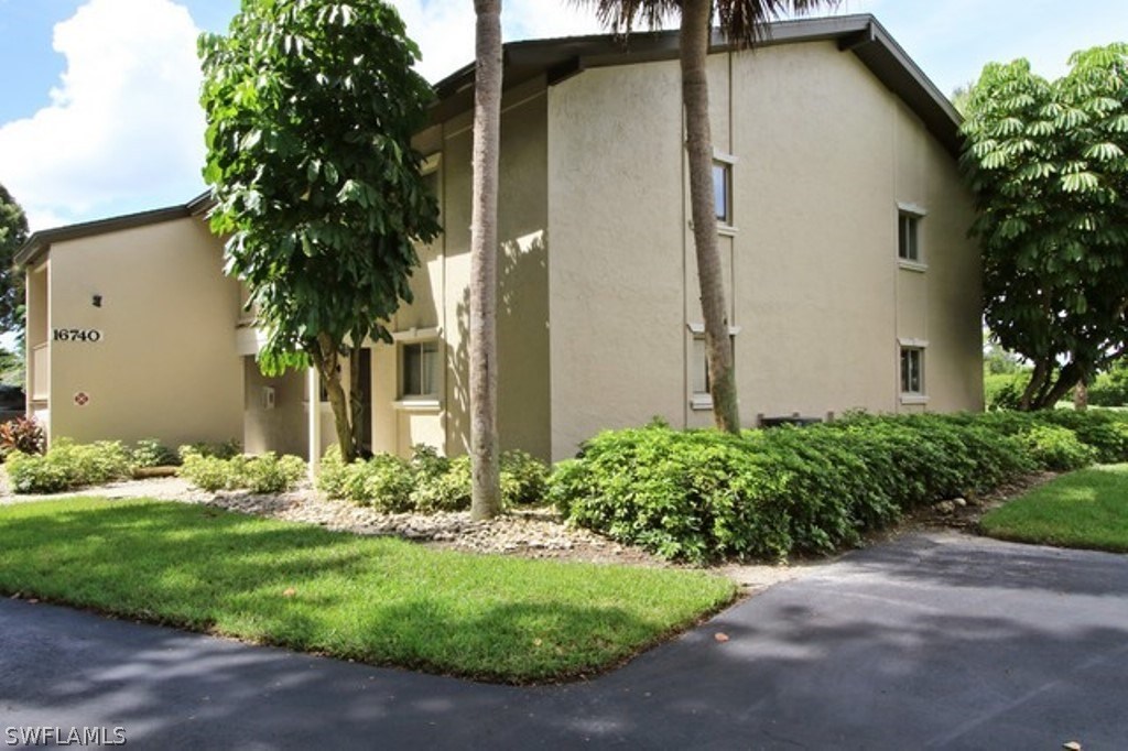 16740 Partridge Place Road, Unit 204 Fort Myers, FL 33908 - Photo 3 of 25 a front view of a house with garden